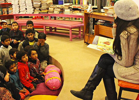 Kids listen as the book The Old Woman and the Eagle is read to them