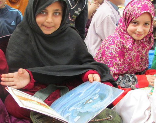 Girls in Pakistan with the book Fatima the Spinner and the Tent