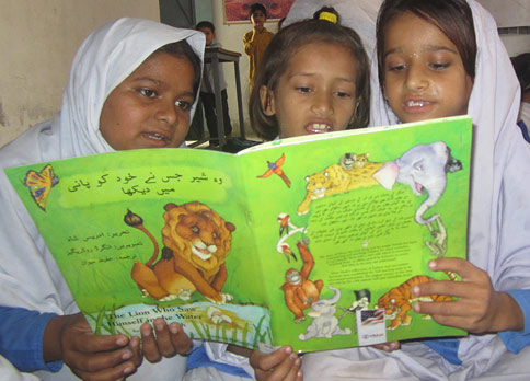 3 Pakistani girls reading The Lion Who Saw Himself in the Water
