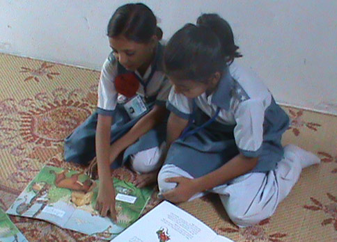 Girls in Pakistan reading The Lion Who Saw Himself in the Water