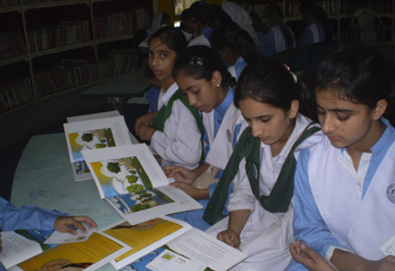 Girls in Pakistan seated reading The Clever Boy and the Terrible, Dangerous Animal