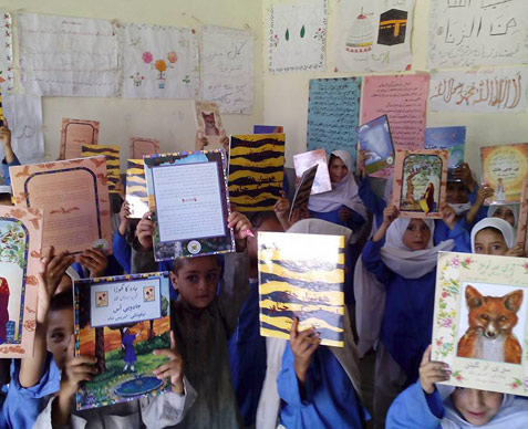 Students from District Malakand holding up Hoopoe Books