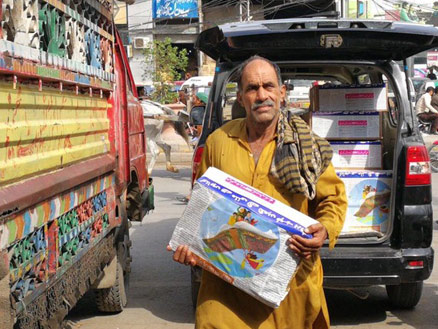 Man delivering a box library in Pakistan
