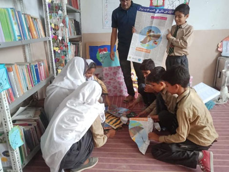 Kids in a Pakistan classroom with books