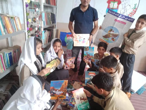 Kids in a Pakistan classroom with books